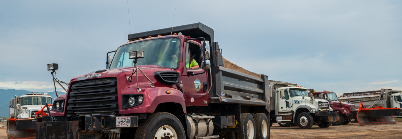 Public Works staff driving maintenance trucks