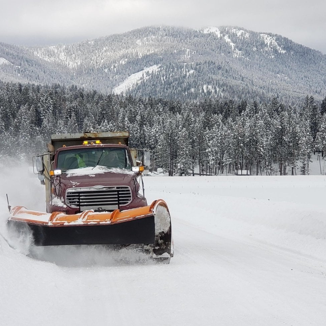 Snow Plow With Mountains In Background