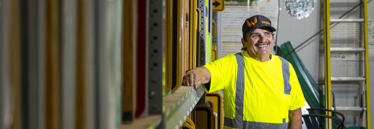 Smiling Public Works employee in the sign shop