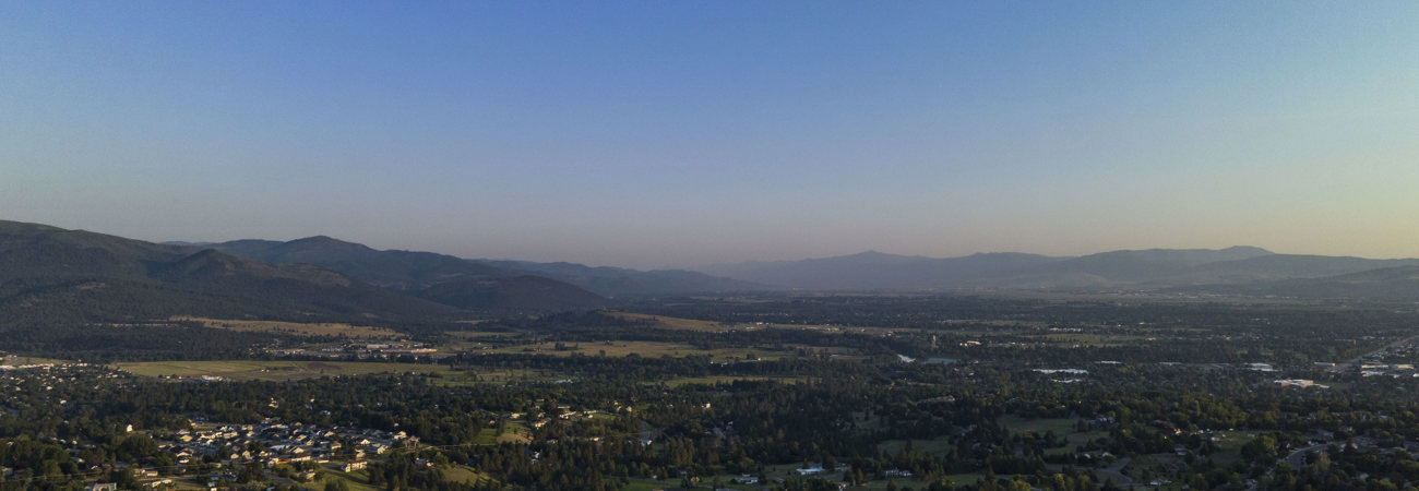 Aerial landscape of Missoula Valley in summer with the Bitterroot mountains in the background