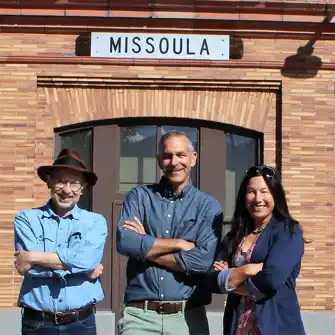 Commissioners standing in front of the former railroad depot