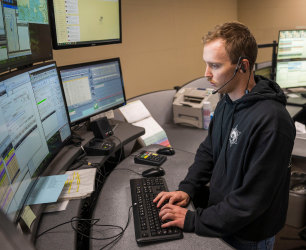 9 1 1 Dispatcher working on a computer